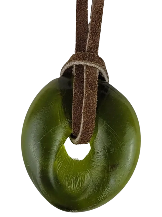 Green donut-shaped object on a brown leather strap against a white background