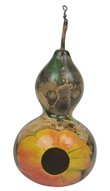 Decorative gourd birdhouse with floral design on a white background
