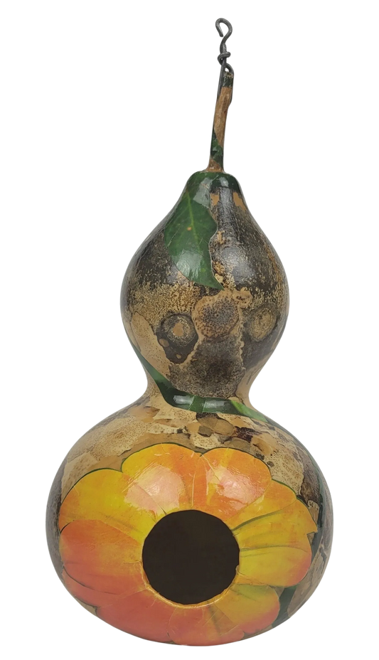Decorative gourd birdhouse with floral design on a white background