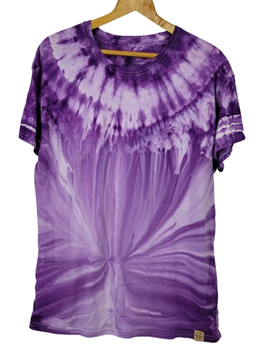 Purple tie-dye t-shirt on a hanger against a white background