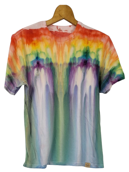 Multicolored tie-dye t-shirt on a wooden hanger against a white background