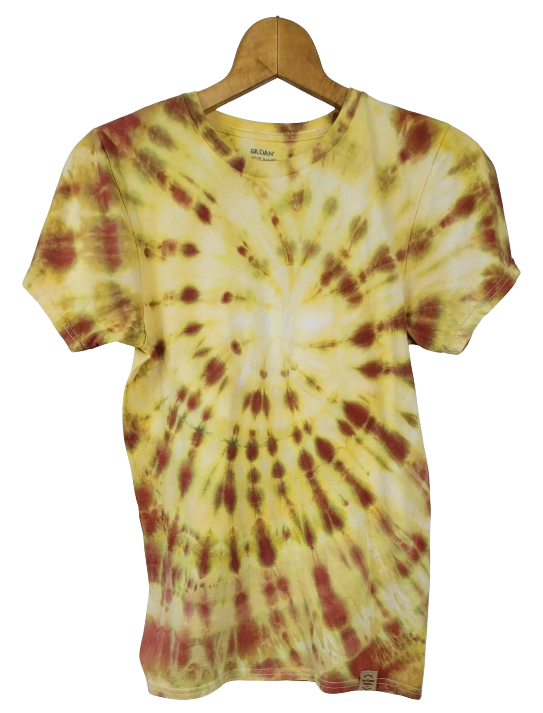 Tie-dye t-shirt with yellow and red pattern on a hanger