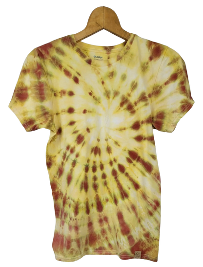 Tie-dye t-shirt with yellow and red pattern on a hanger