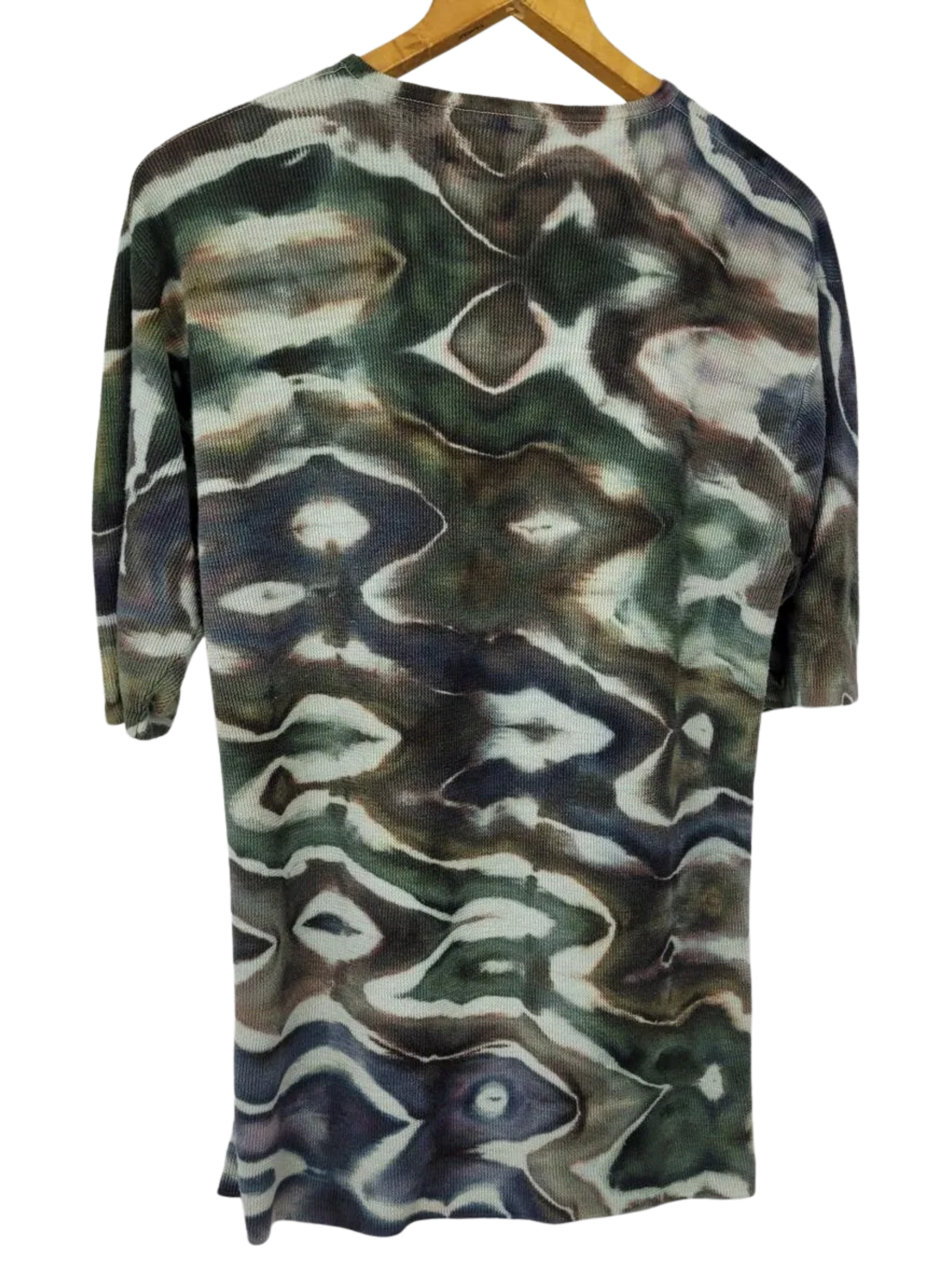 Glitch patterned tie dye hemp shirt on a hanger with a white background