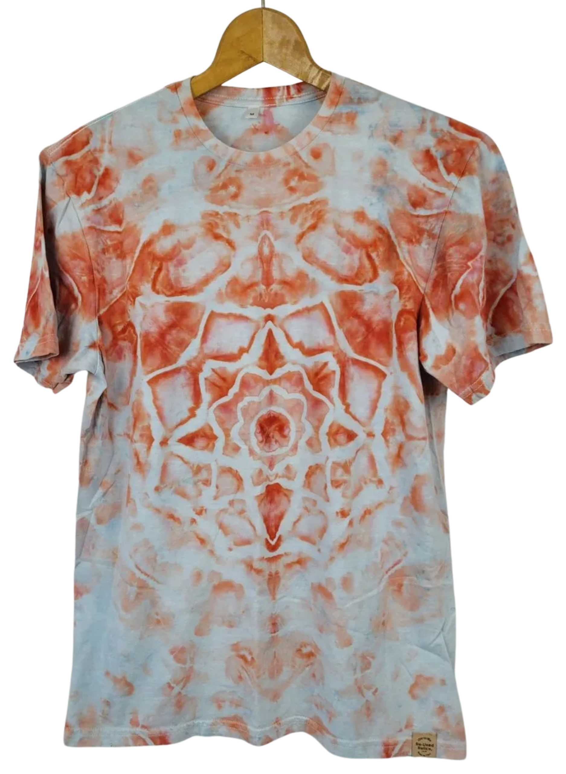 Tie-dye t-shirt with orange and white pattern on a hanger