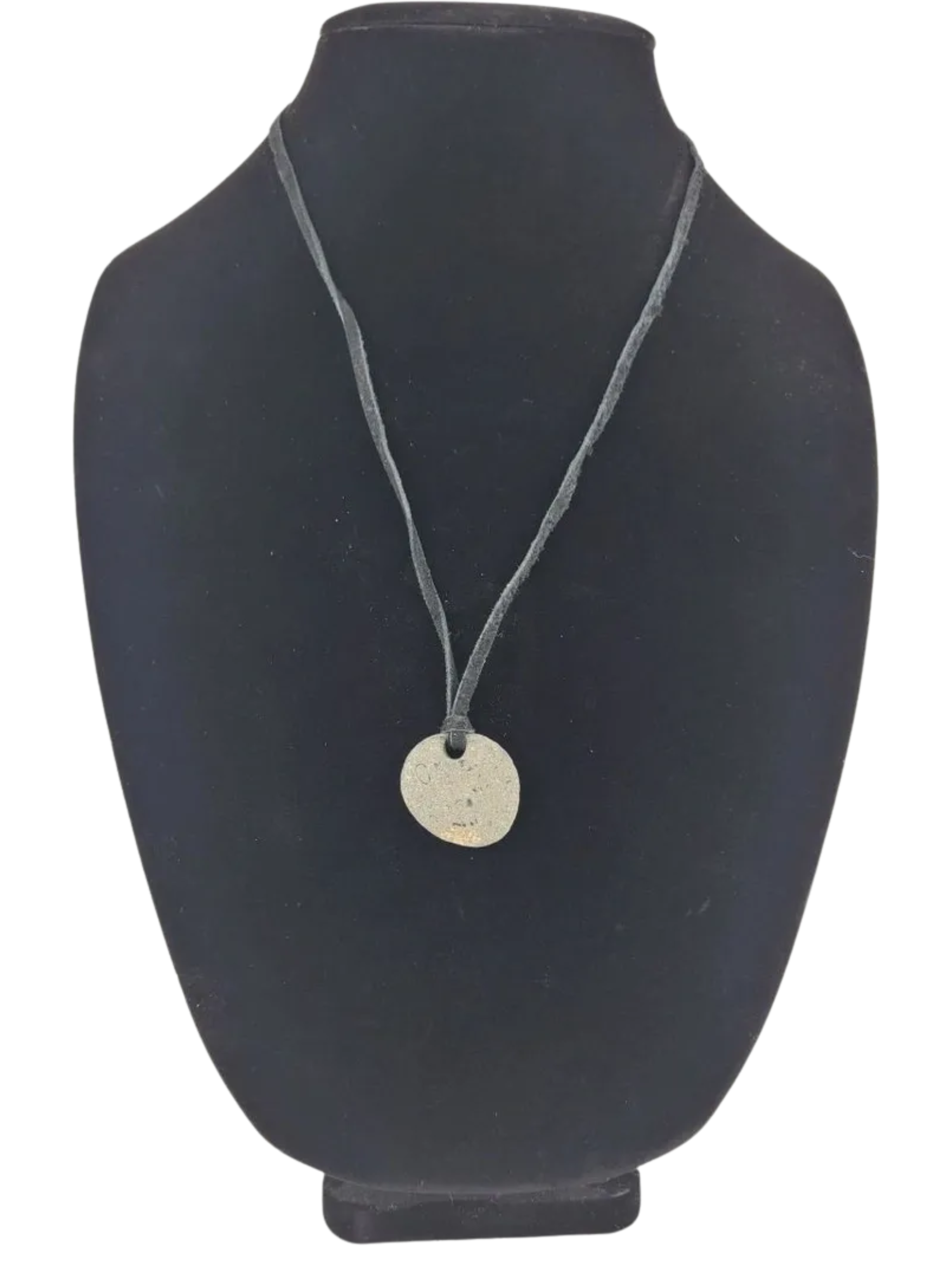 Necklace with a round pendant on a black mannequin bust