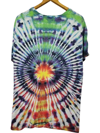 Tie-dye t-shirt with a colorful spiral pattern on a hanger against a white background