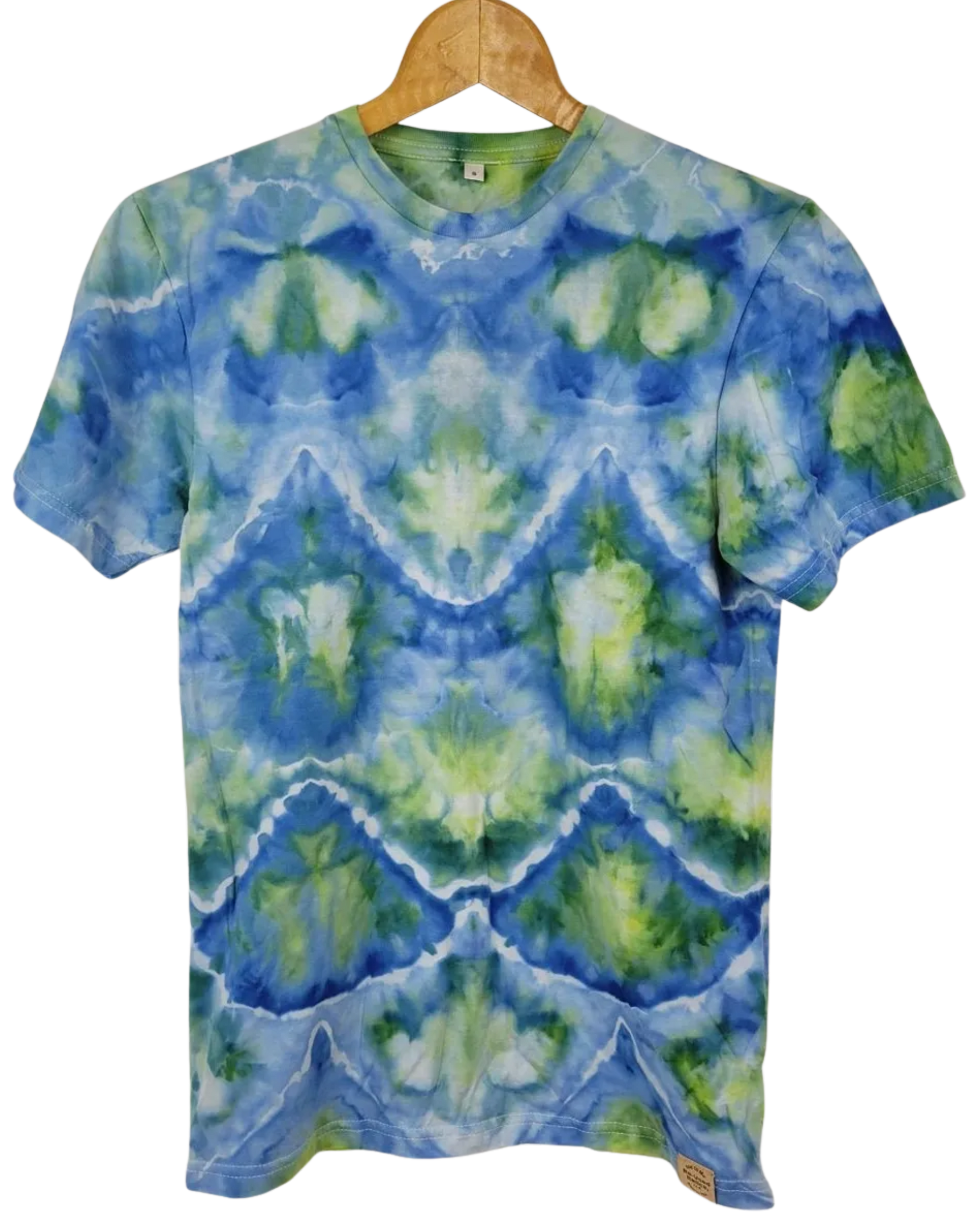 Tie-dye t-shirt with blue and green pattern on a wooden hanger