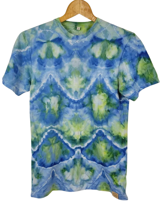 Tie-dye t-shirt with blue and green pattern on a wooden hanger