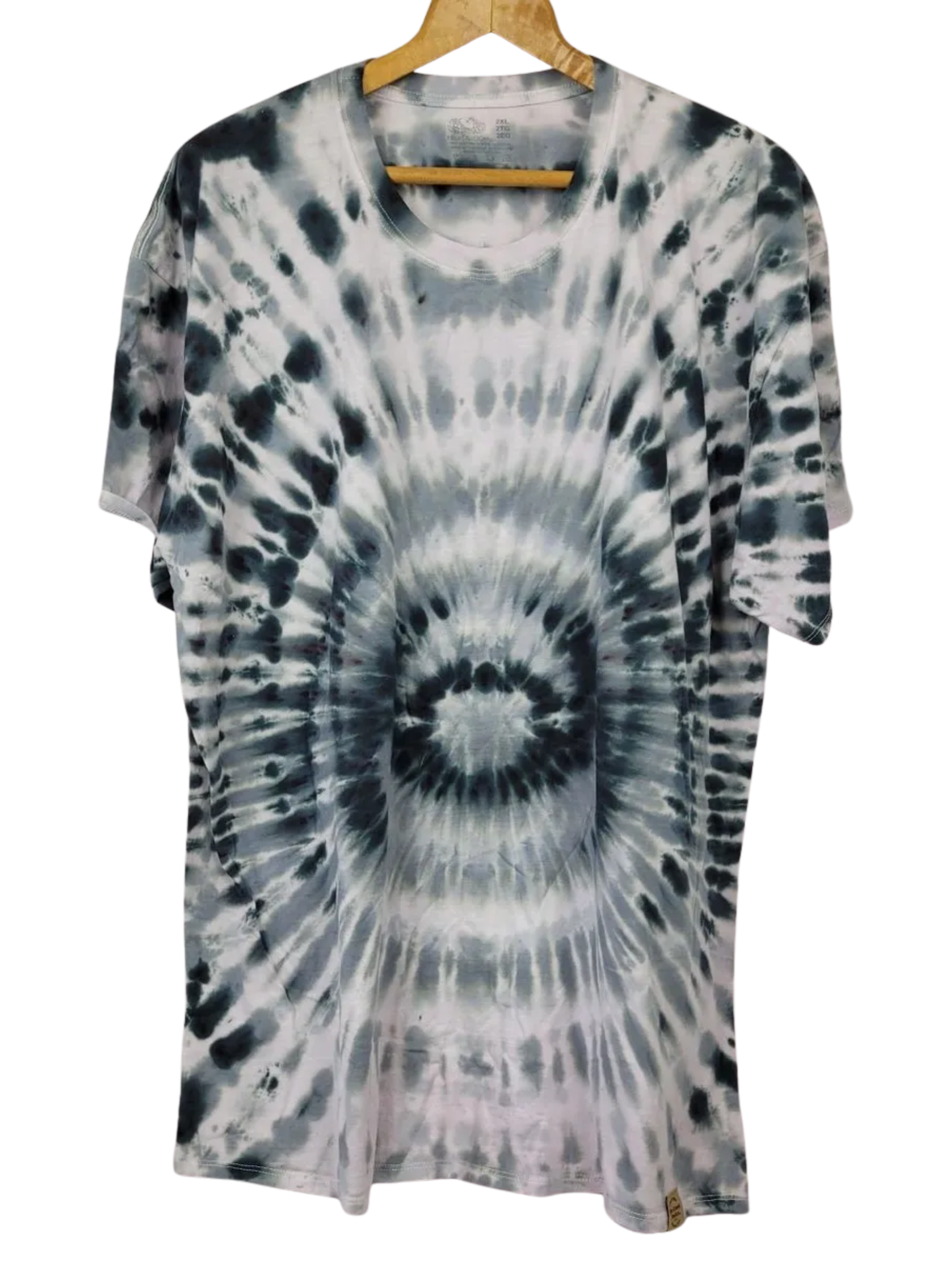 Tie-dye t-shirt on a hanger with a white background