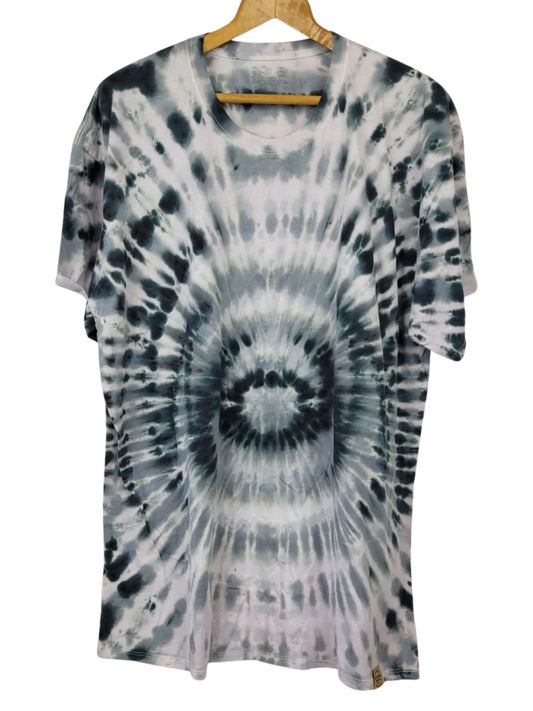 Tie-dye t-shirt on a hanger with a white background