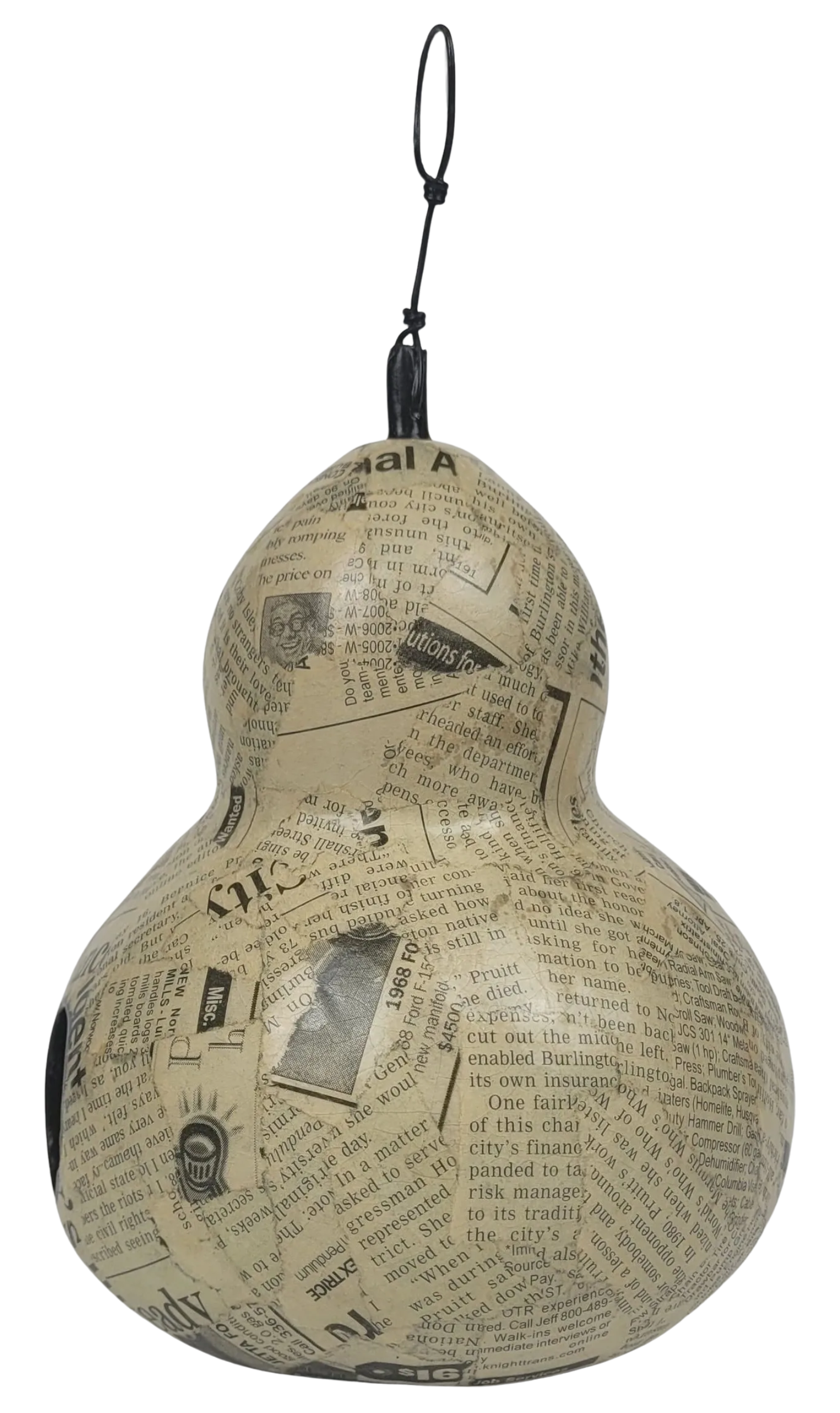 Decorative gourd with newspaper print on a white background