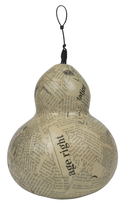 Decorative gourd with newspaper print and 'age right' text on a white background