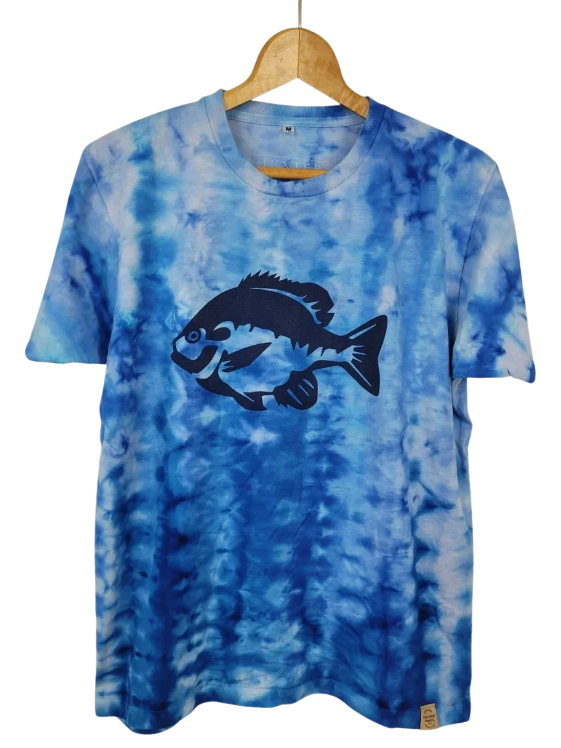 Blue tie-dye t-shirt with a fish graphic on a hanger