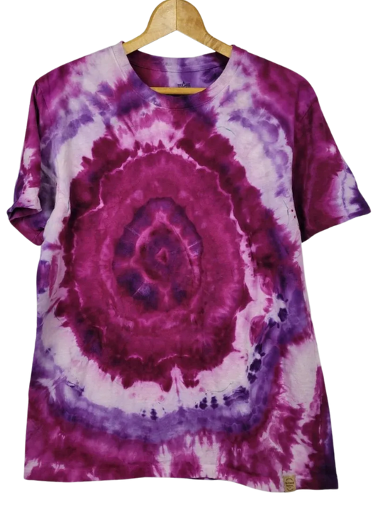 Tie-dye t-shirt with purple and pink spiral pattern on a hanger