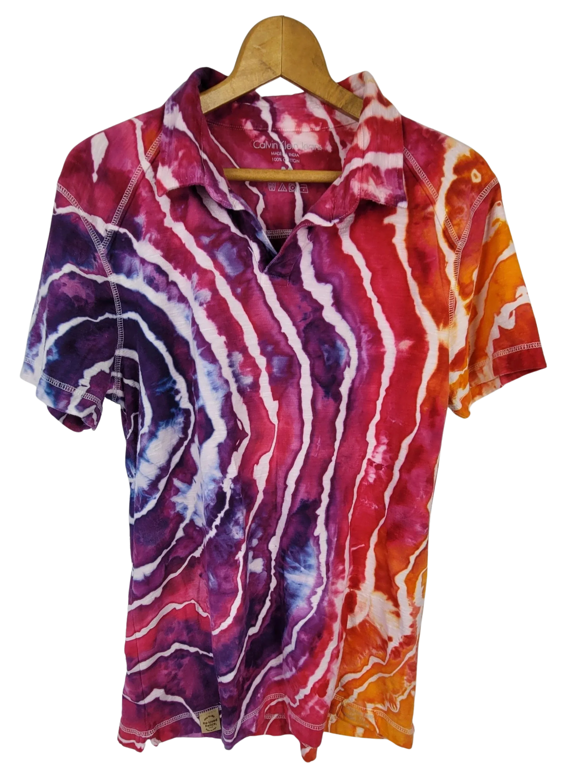Colorful tie-dye shirt on a hanger against a white background