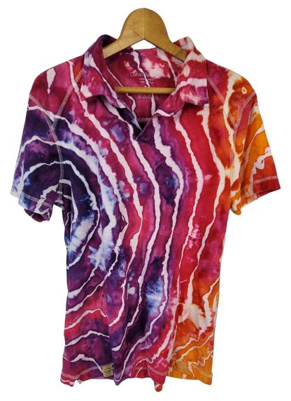 Colorful tie-dye shirt on a hanger against a white background