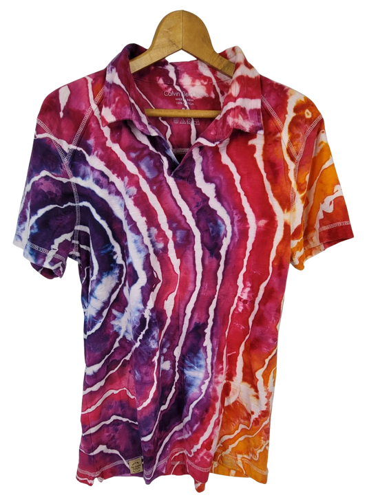 Colorful tie-dye shirt on a hanger against a white background