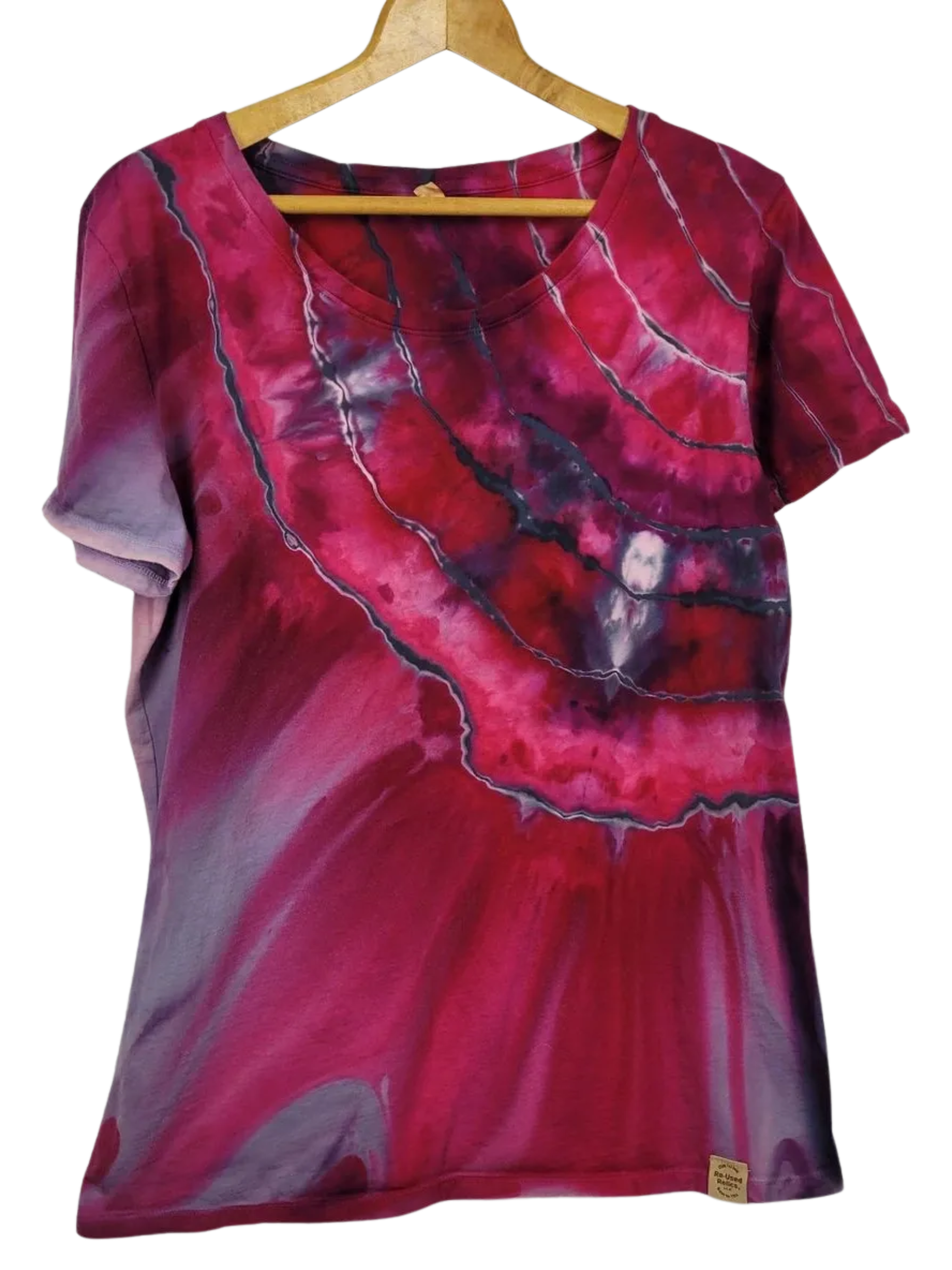 Red and purple tie-dye shirt on a wooden hanger against a white background