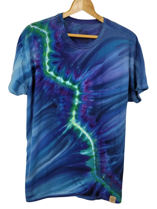Tie-dye t-shirt with blue and green patterns on a hanger against a white background