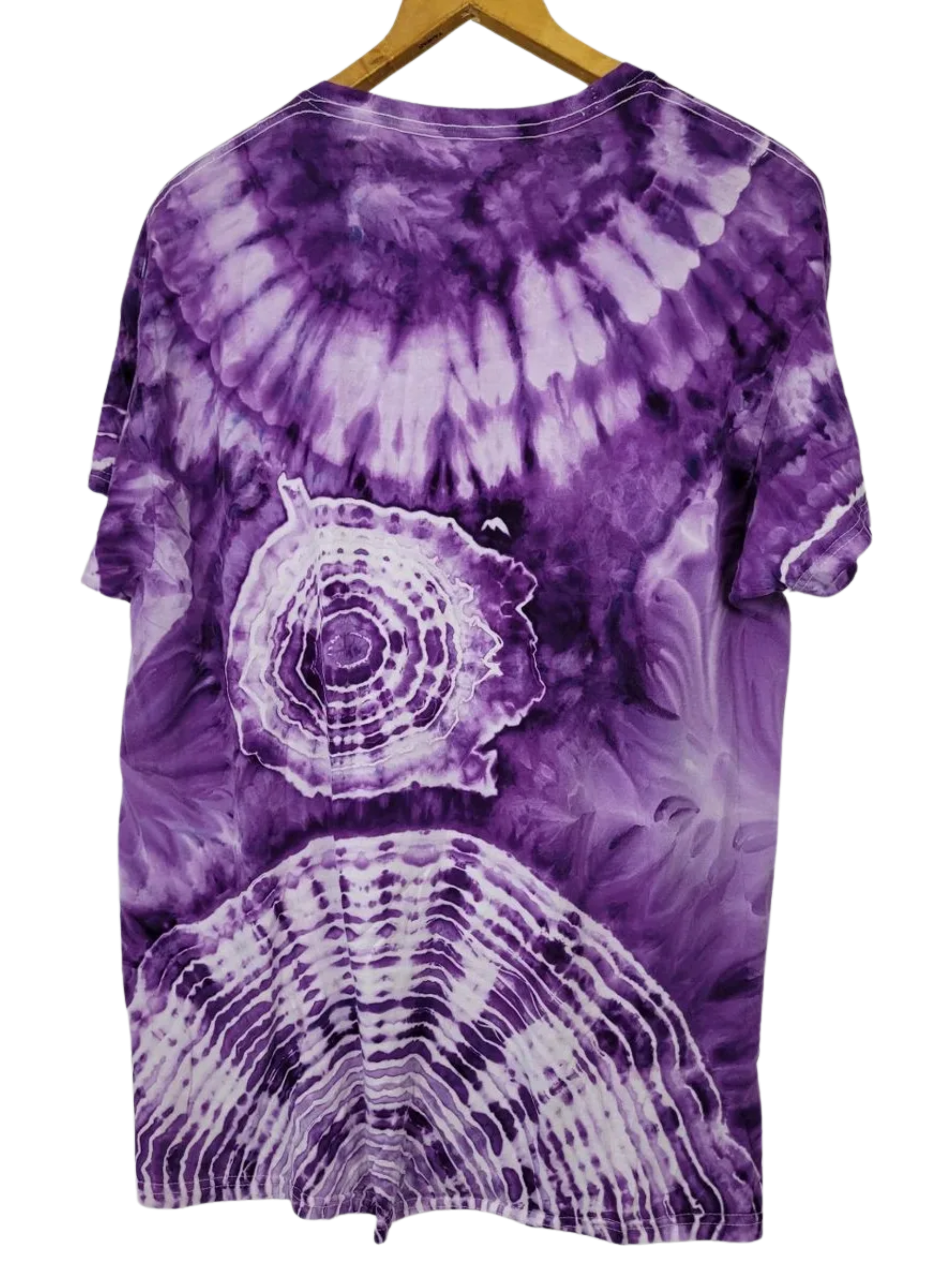 Purple tie-dye t-shirt with a circular pattern on a hanger against a white background