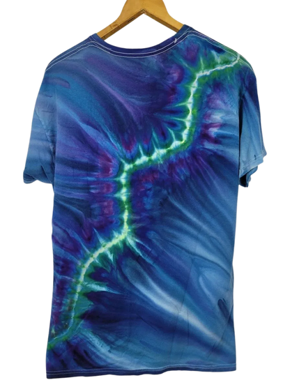 Tie-dye t-shirt with blue and green patterns on a hanger