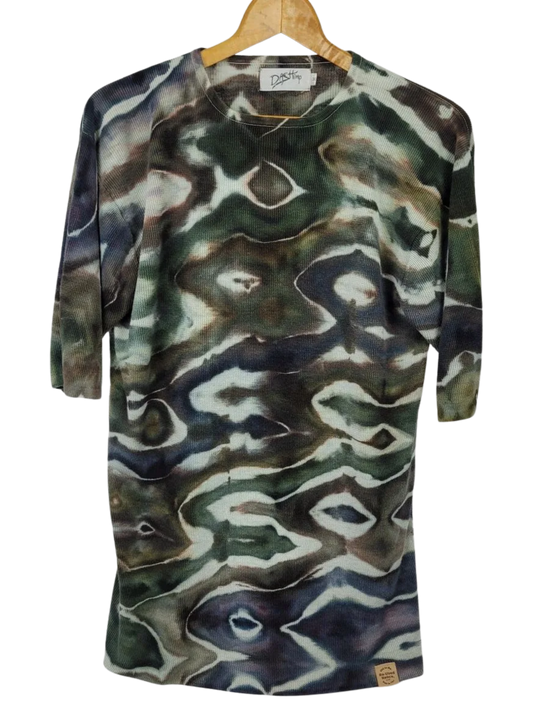 Camouflage-patterned shirt on a hanger with a visible brand label.