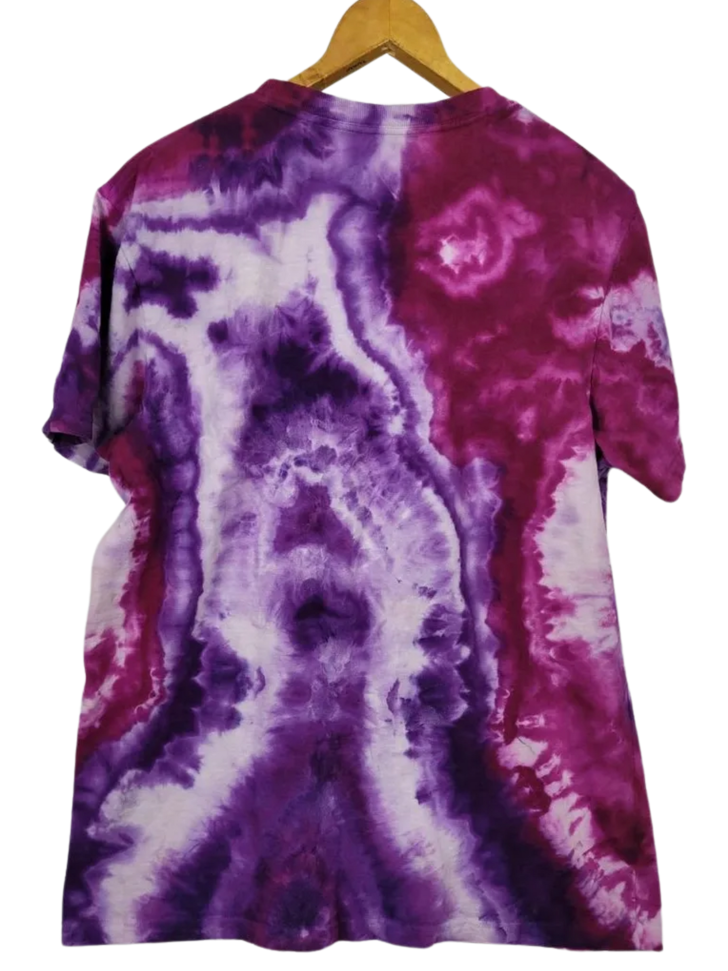 Tie-dye t-shirt with purple and pink patterns on a hanger