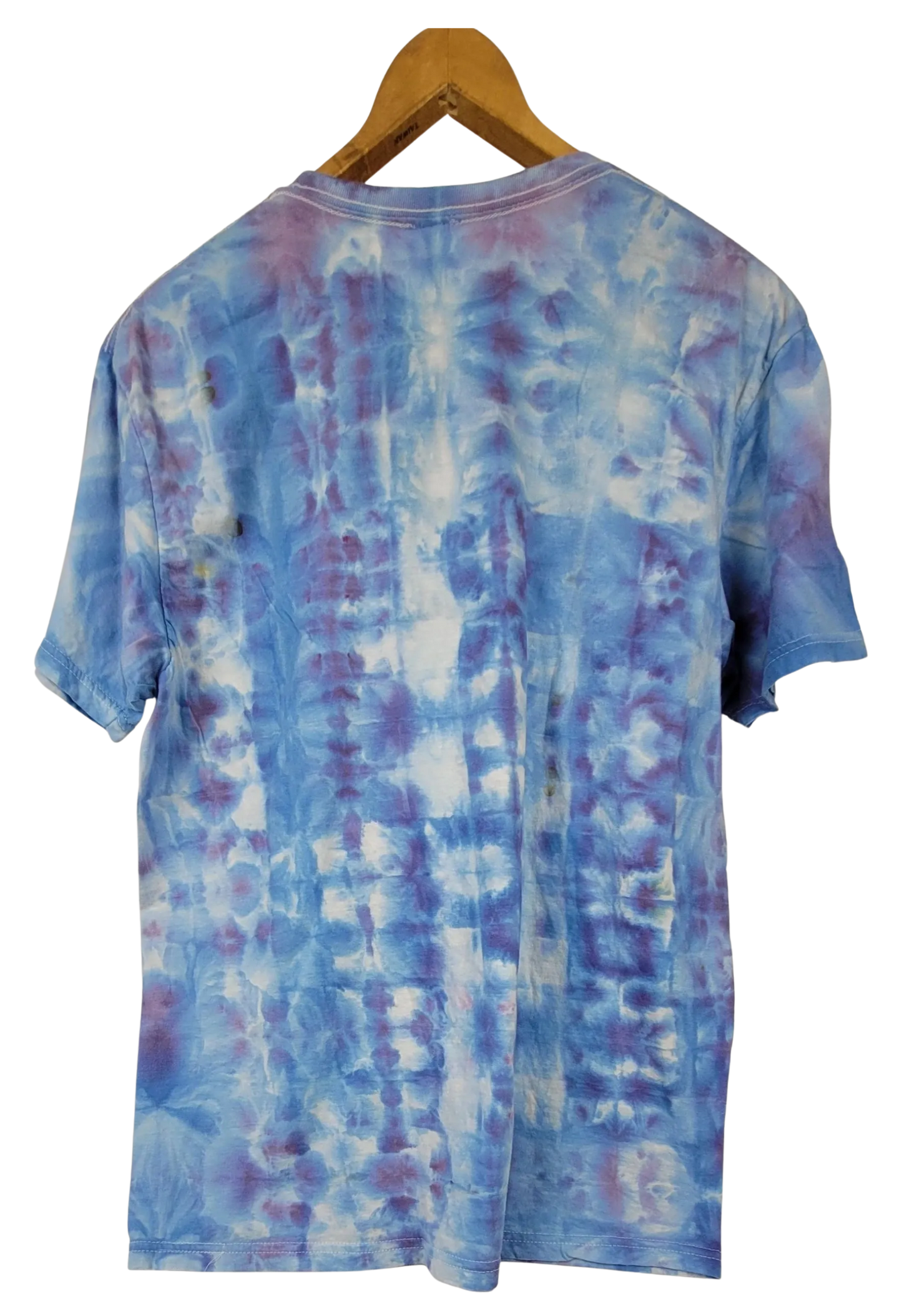 Blue tie-dye t-shirt on a wooden hanger with a white background