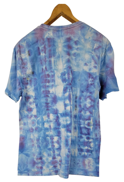 Blue tie-dye t-shirt on a wooden hanger with a white background
