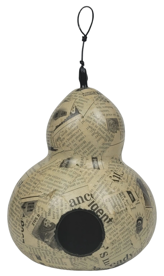 Gourd-shaped birdhouse with newspaper print on a white background